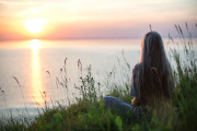 photo-of-woman-sitting-on-grass-during-golden-hour-4640845