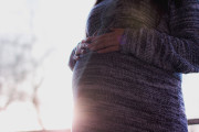 pregnant-woman-wearing-marled-gray-sweater-touching-her-54289-1